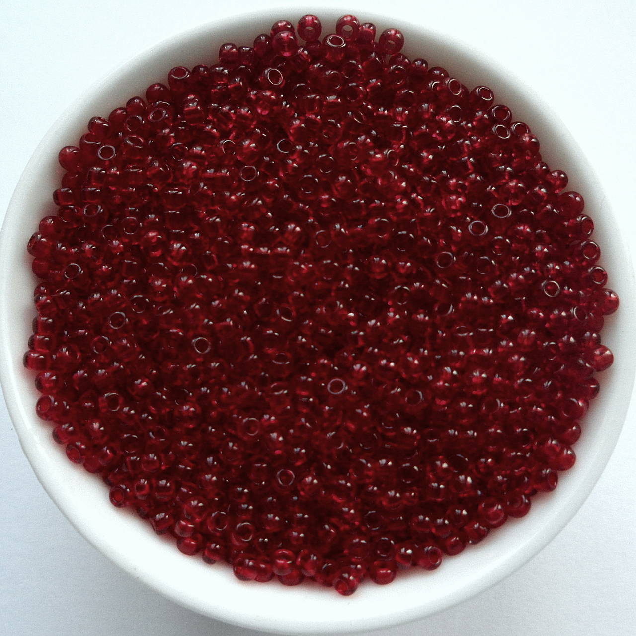 Rokajl 11/0 PRECIOSA 2mm TRANSP-10g (rubínová)