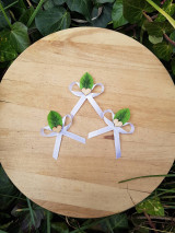 biele svadobné pierka so zeleným lístočkom a dreveným srdiečkom