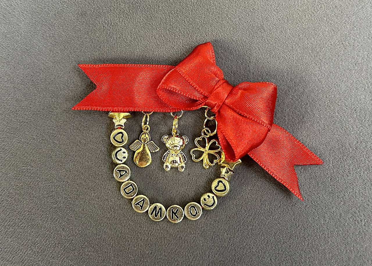 Mašlička/stužka proti urieknutiu na kočík/vajíčko s anjelikom, štvorlístkom, macíkom a menom