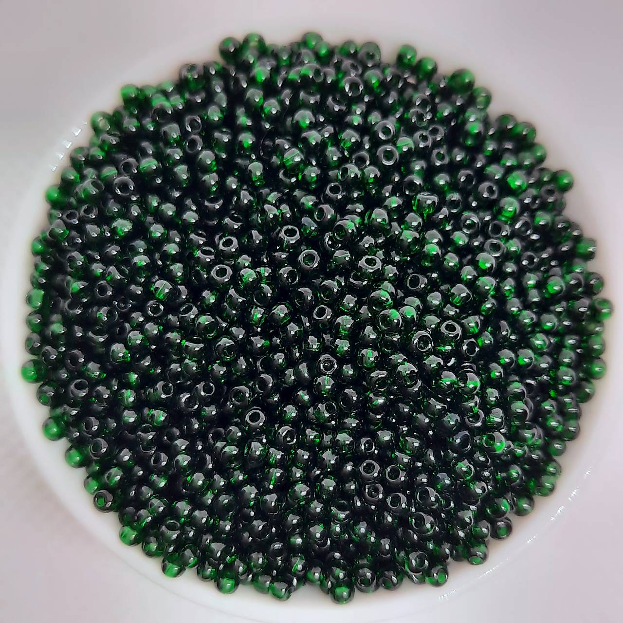 Rokajl 11/0 PRECIOSA 2mm TRANSP-10g (zelená tmavá)