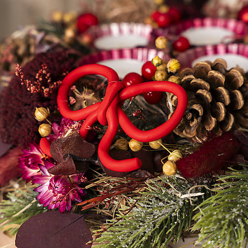 Adventný svietnik/veniec/ so sviečkami v prírodnom bordovom vzhľade.